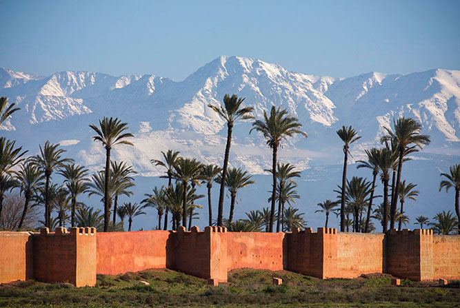 The medina walls and distant snow-capped Atlas Mountains